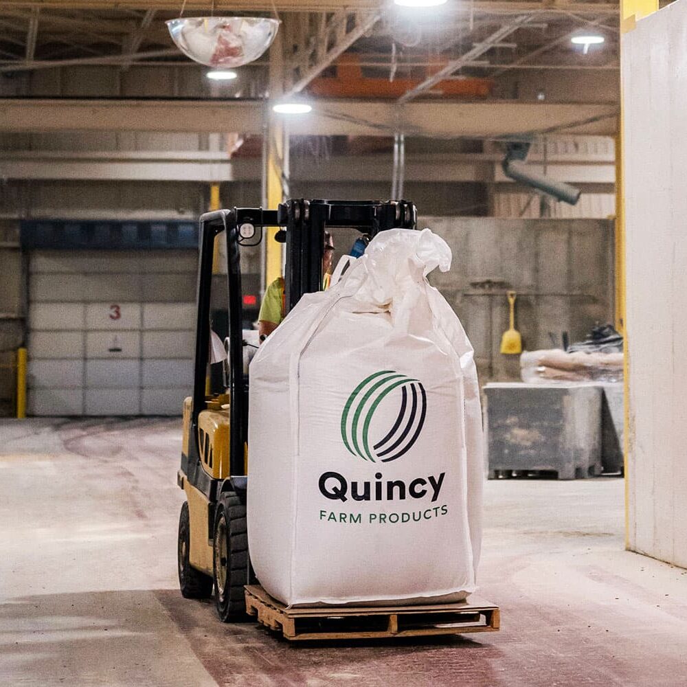 forklift with agriculture product from Quincy Farm Products