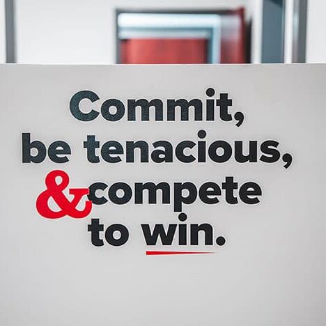 Wall graphic that says Commit, be tenacious, and compete to win